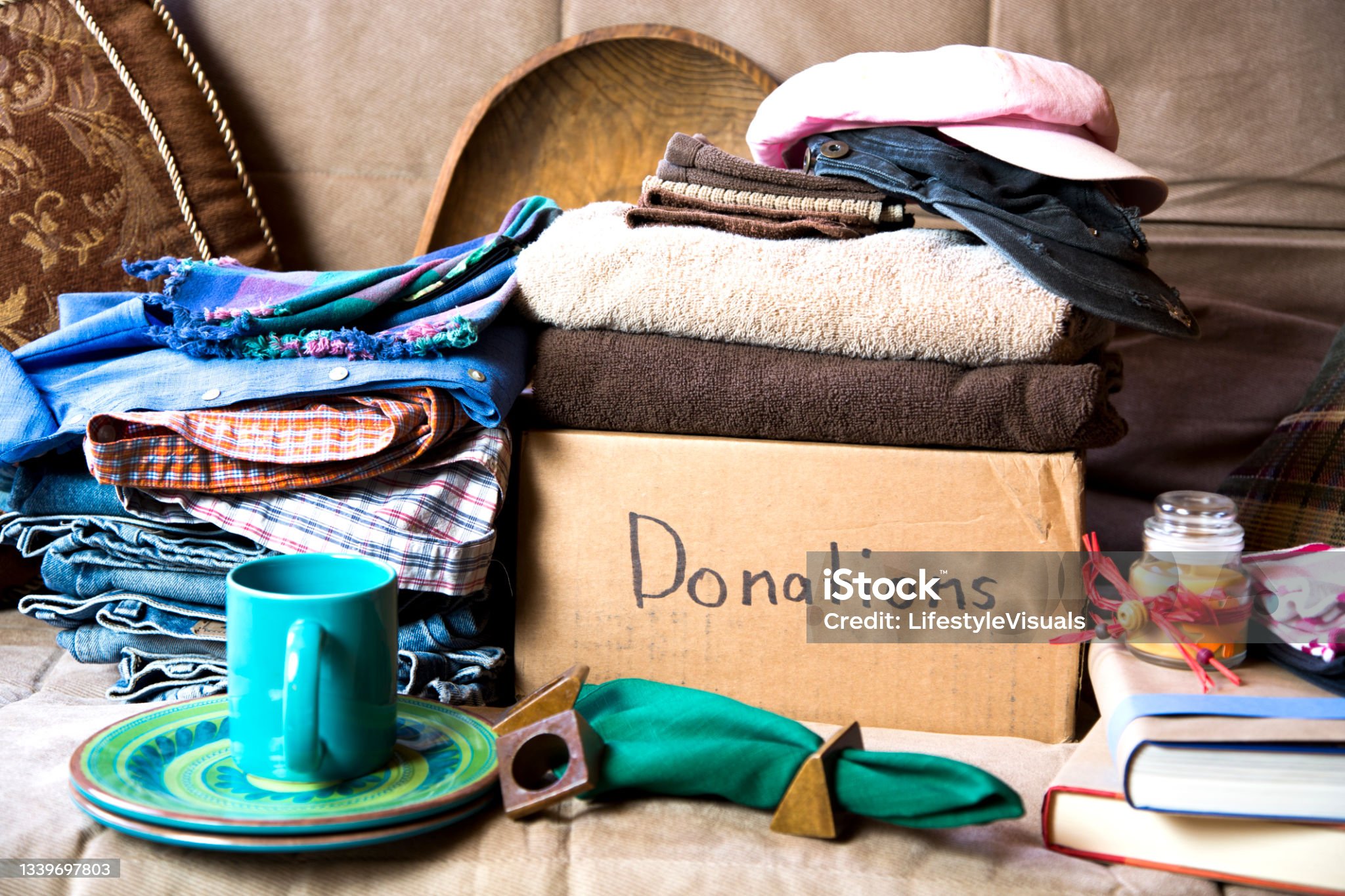 Pile of clothes and other items on box marked